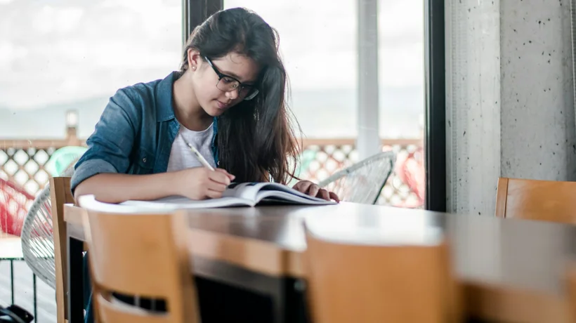 A pharmacy student studying at a table